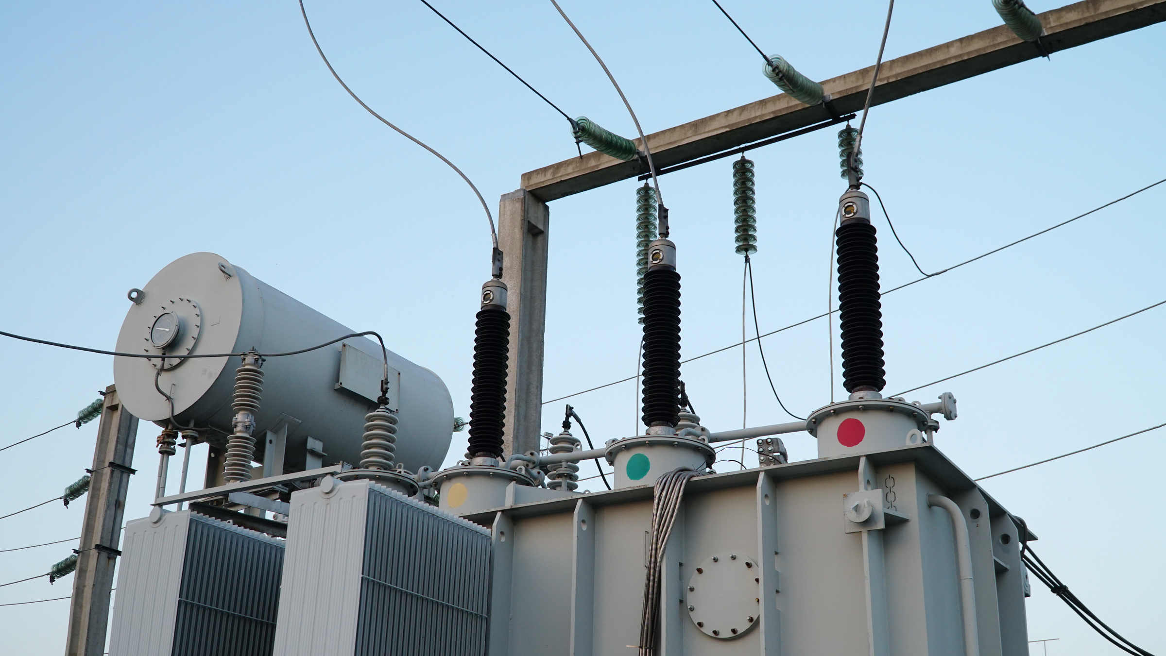 Power transformer. Electrical equipment. Electric substation. High voltage transformer against the blue sky. Electric current redistribution substation